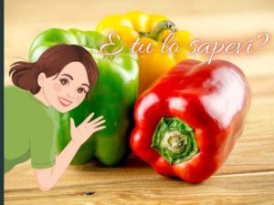 dei peperoni di diverso colore e una donna che spunta da un lato